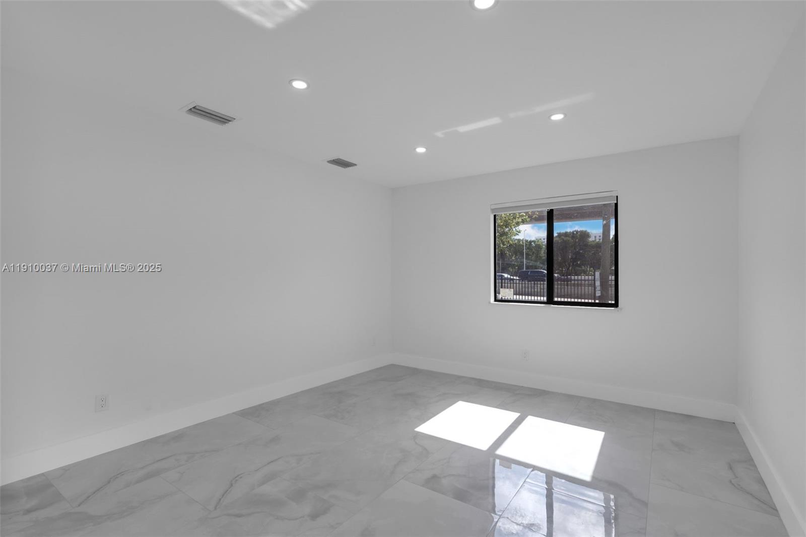 1411 Northwest 40th Street Miami, FL 33142 - Photo 6 of 52 an empty room with a workspace