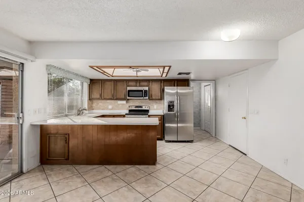 a kitchen with stainless steel appliances a sink and a refrigerator