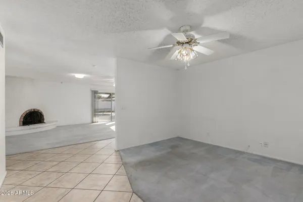 a view of a livingroom with a ceiling fan and window
