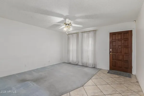 an empty room with a empty space and windows