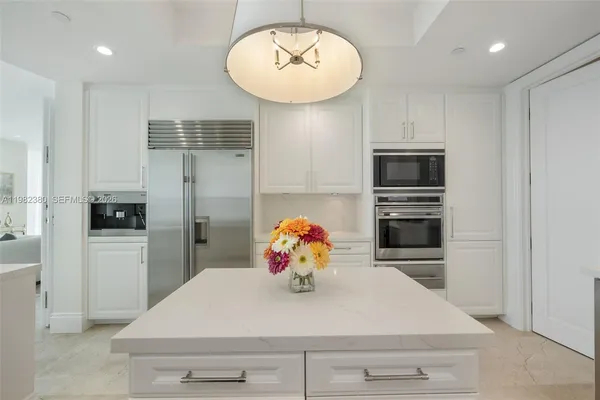 a kitchen with stainless steel appliances a refrigerator and microwave
