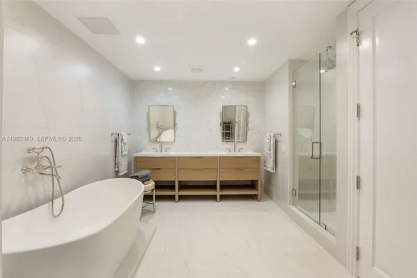 a bathroom with a bathtub and a shower
