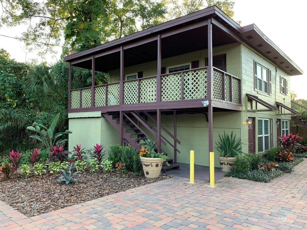 a front view of a house with plants
