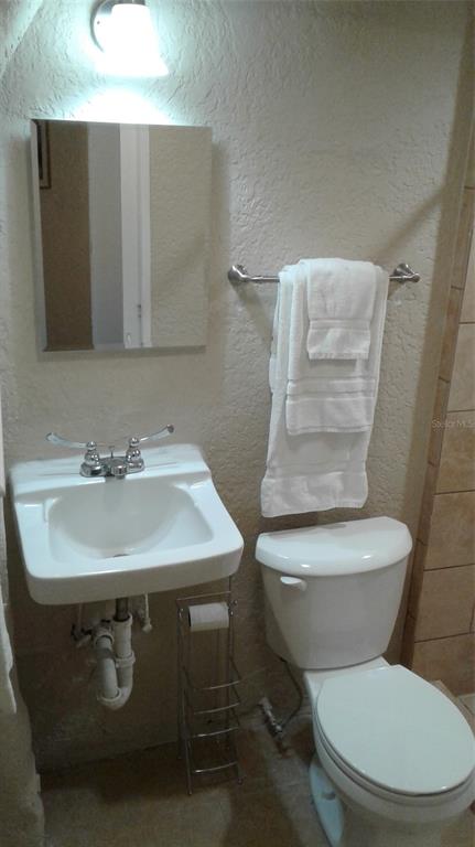 2512 Musselwhite Avenue, Unit 3 Orlando, FL 32804 - Photo 3 of 9 a bathroom with a sink toilet and mirror