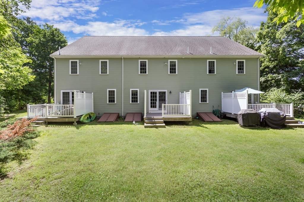 49 Beaver Street, Unit 49 Franklin, MA 02038 - Photo 31 of 46 a view of a house with backyard porch and sitting area