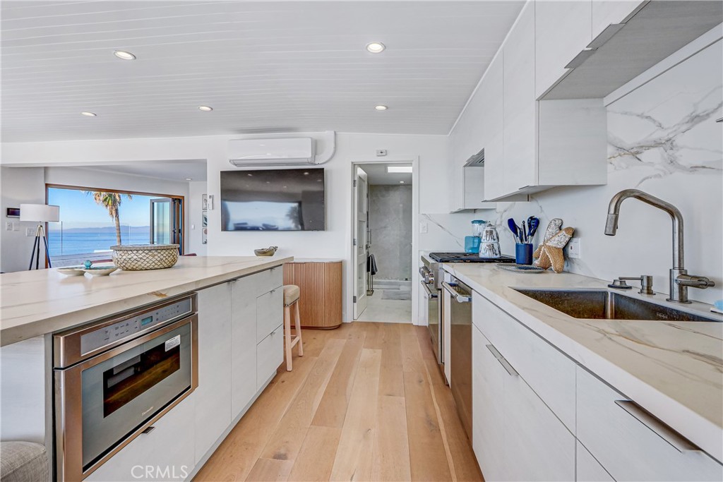 230 40th Street, Unit 3 Manhattan Beach, CA 90266 - Photo 12 of 38 a kitchen with a sink stove top oven and microwave
