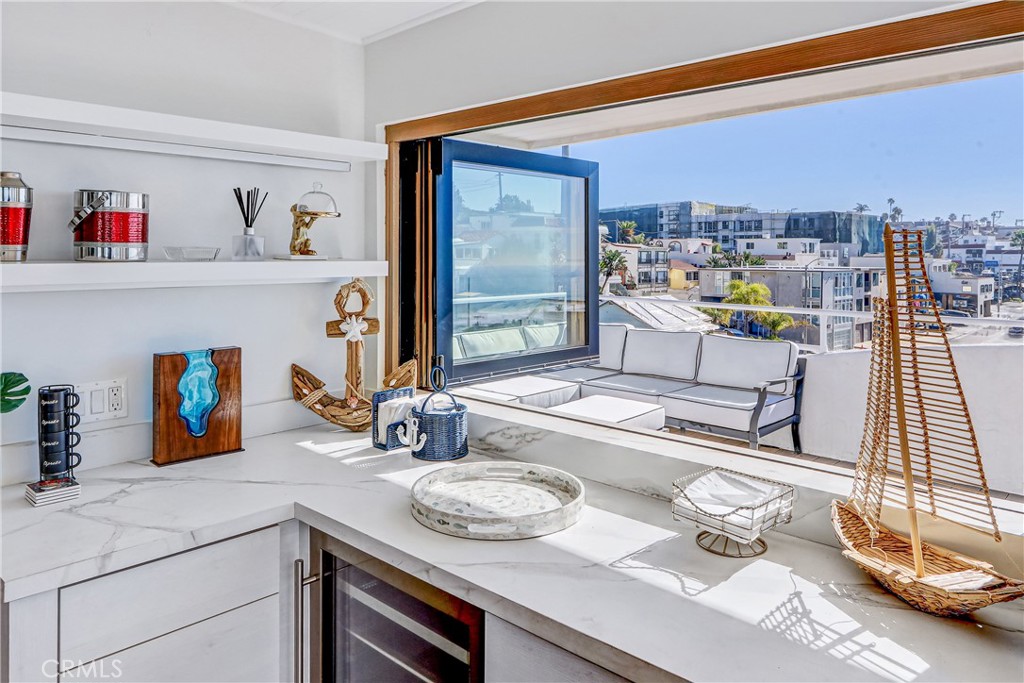 230 40th Street, Unit 3 Manhattan Beach, CA 90266 - Photo 13 of 38 a living room with furniture and a floor to ceiling window