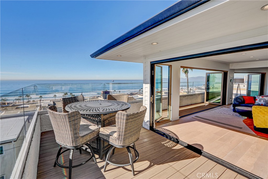230 40th Street, Unit 3 Manhattan Beach, CA 90266 - Photo 17 of 38 a view of a patio with table and chairs with wooden floor and fence