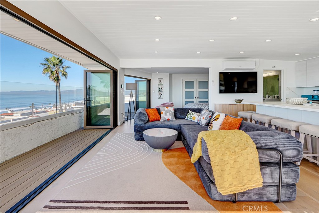 230 40th Street, Unit 3 Manhattan Beach, CA 90266 - Photo 4 of 38 a living room with furniture and a flat screen tv