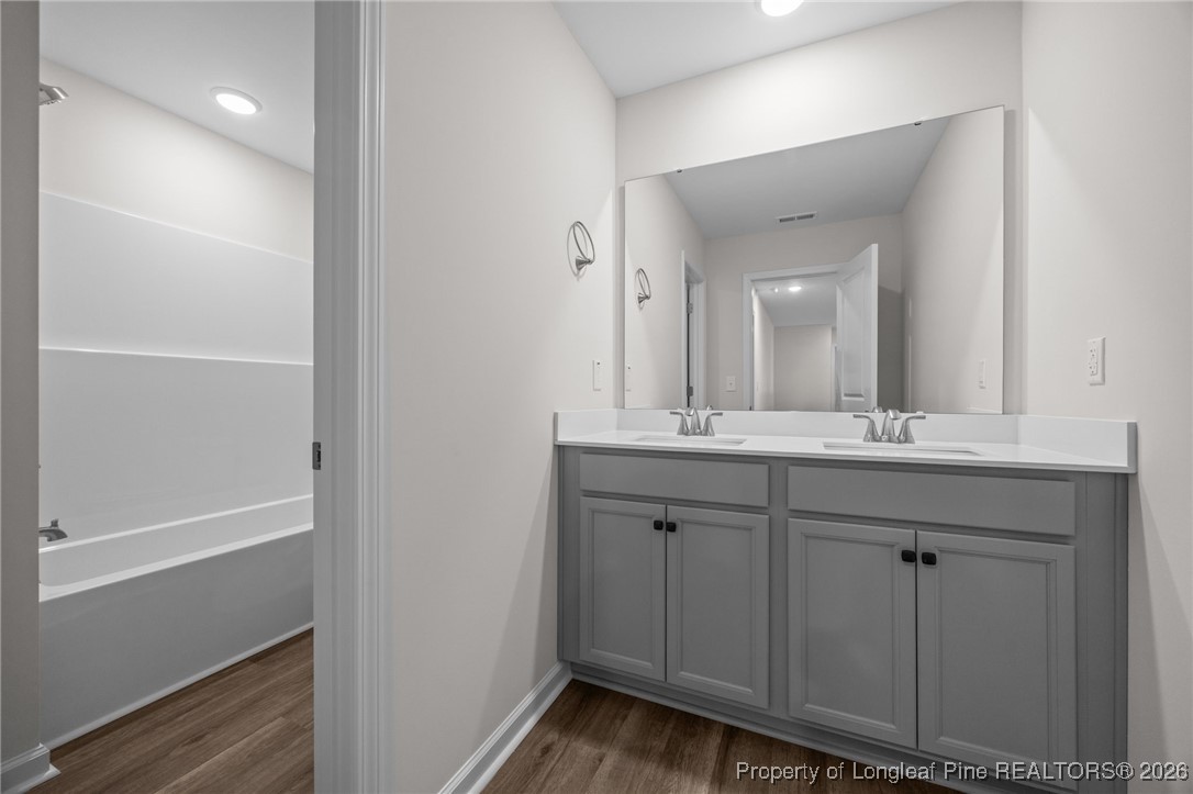 96 Regis Lane Coats, NC 27521 - Photo 22 of 36 a bathroom with a double vanity sink and a mirror