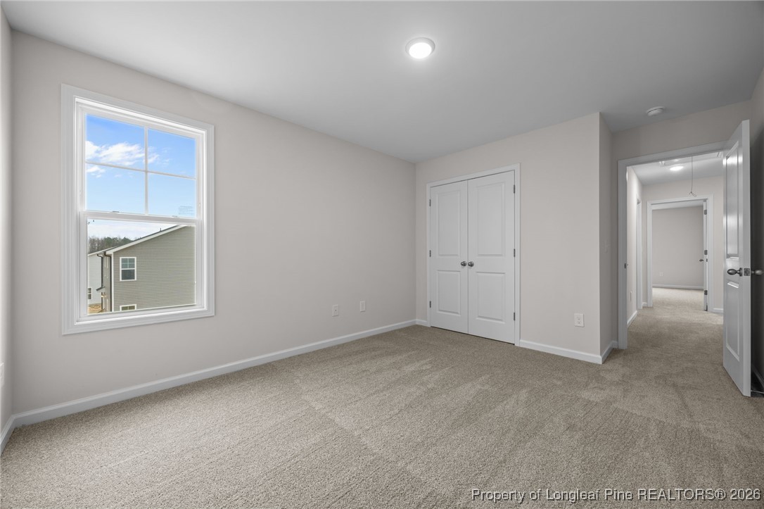96 Regis Lane Coats, NC 27521 - Photo 23 of 36 an empty room with windows and closet