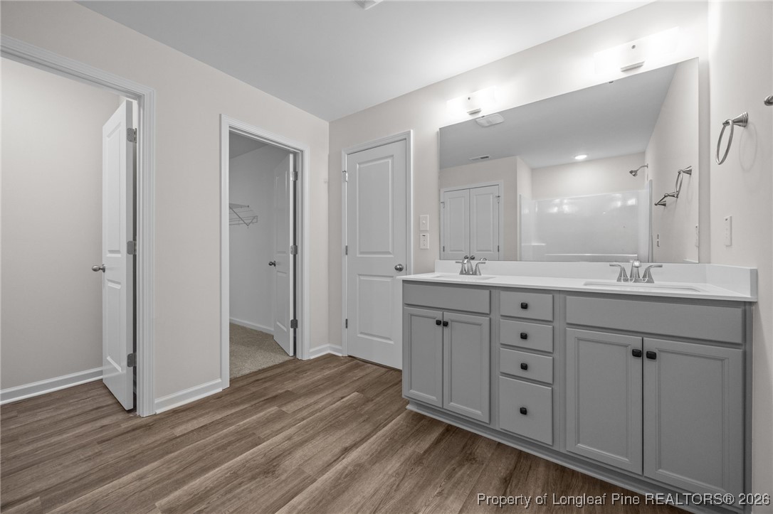 96 Regis Lane Coats, NC 27521 - Photo 28 of 36 a spacious bathroom with a double vanity sink a mirror and a shower