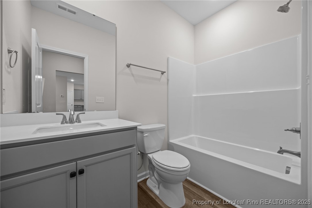 96 Regis Lane Coats, NC 27521 - Photo 30 of 36 a bathroom with a sink a toilet and shower