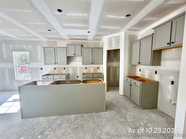a kitchen with stainless steel appliances granite countertop a refrigerator stove top oven a sink and dishwasher