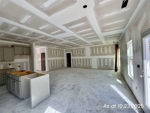 a view of an empty room with kitchen