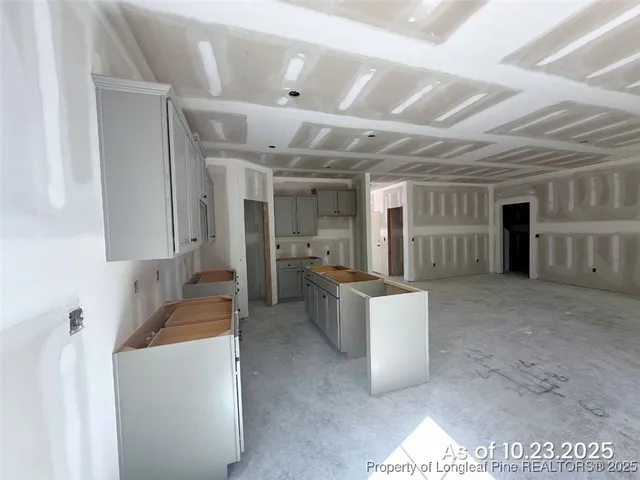 a large room with a large window and furniture