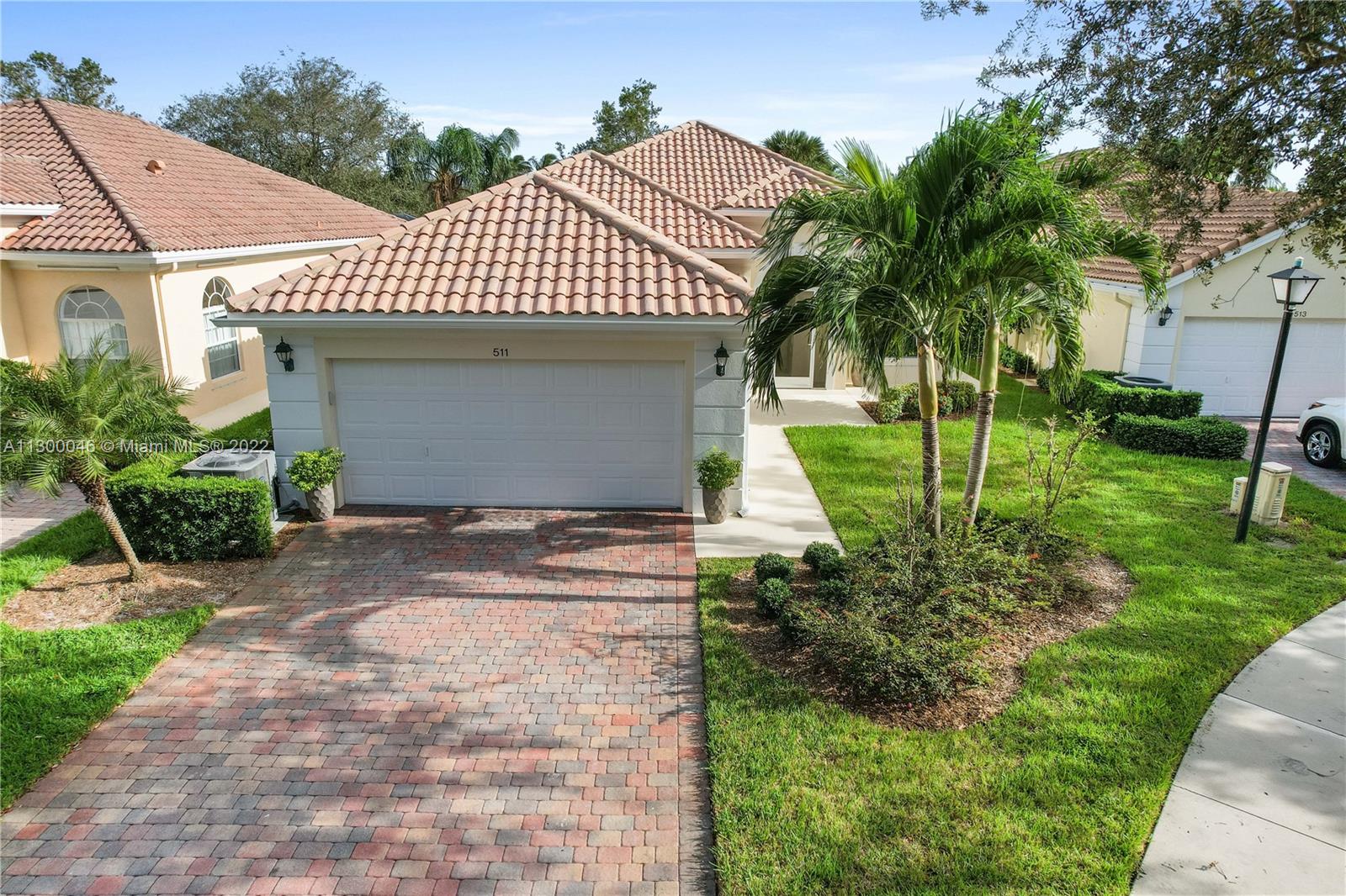 a front view of a house with a garden and plants