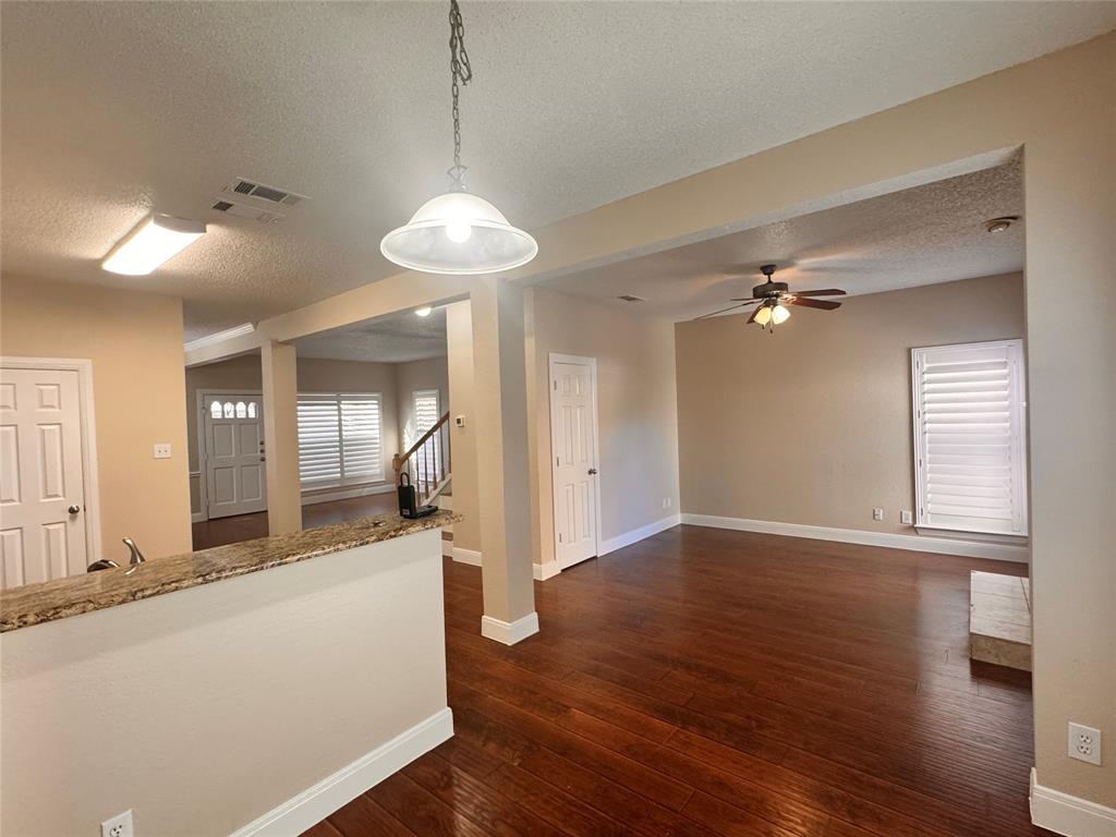 9435 Blue Jay Way Irving, TX 75063 - Photo 11 of 27 a view of a big room with wooden floor and a chandelier