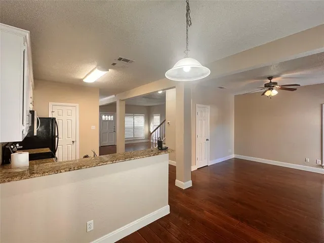 a view of a living room a hallway and wooden floor