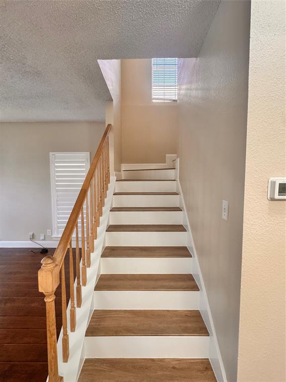 9435 Blue Jay Way Irving, TX 75063 - Photo 15 of 27 a view of staircase with wooden floor and white walls
