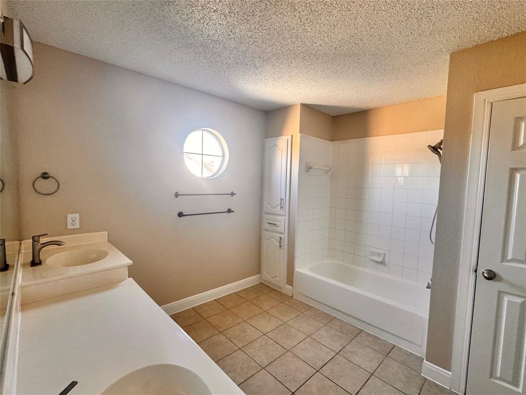 9435 Blue Jay Way Irving, TX 75063 - Photo 20 of 27 a bathroom with a tub shower and sink