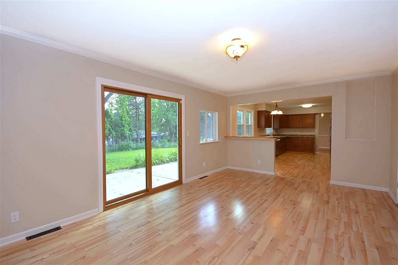 5181 Welsh Road Rockford, IL 61107 - Photo 7 of 24 a view of an empty room with a window and wooden floor