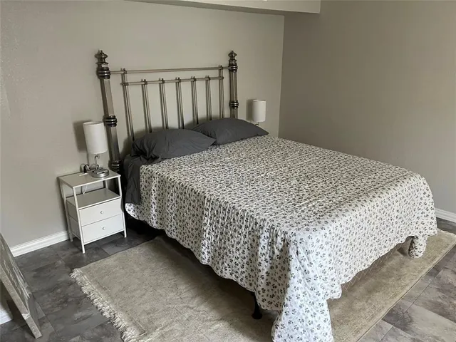 a bed sitting in a bedroom next to a window