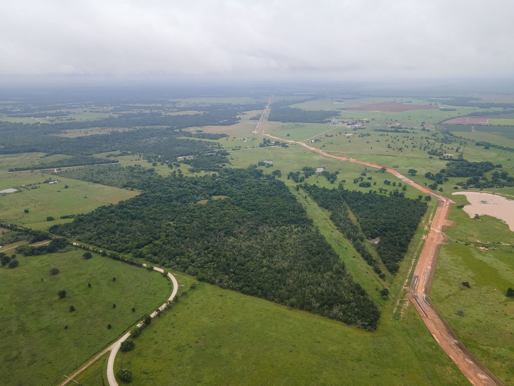 a view of a field with an ocean