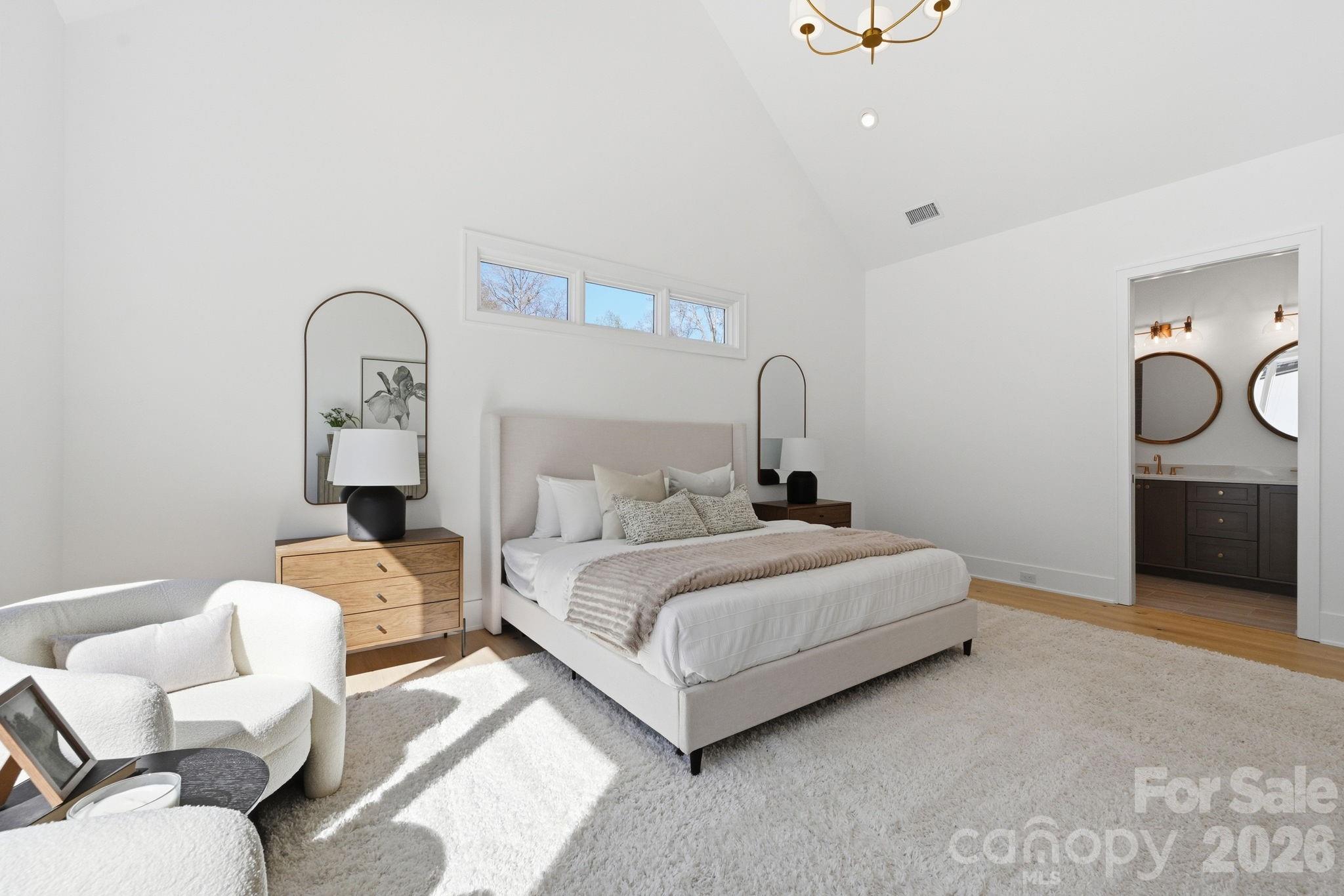 610 Walnut Street Davidson, NC 28036 - Photo 16 of 33 a bedroom with bed and a chandelier