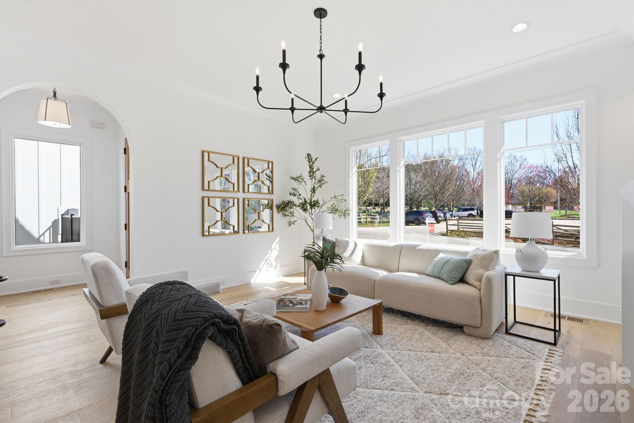 610 Walnut Street Davidson, NC 28036 - Photo 2 of 33 a living room with couch a dining table and a chandelier
