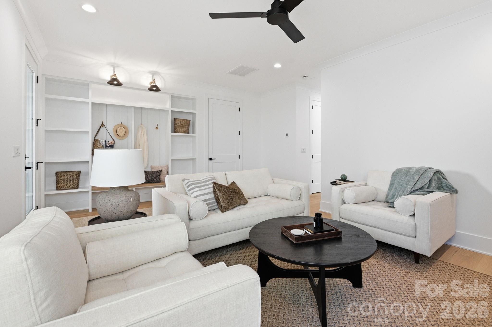 610 Walnut Street Davidson, NC 28036 - Photo 25 of 33 a living room with furniture and a chandelier