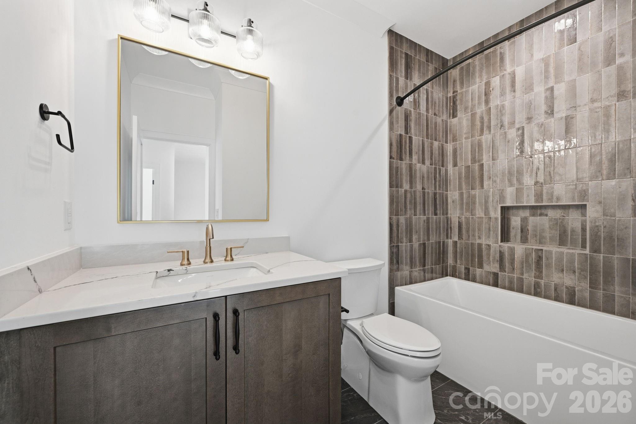 610 Walnut Street Davidson, NC 28036 - Photo 29 of 33 a bathroom with a sink a toilet and shower