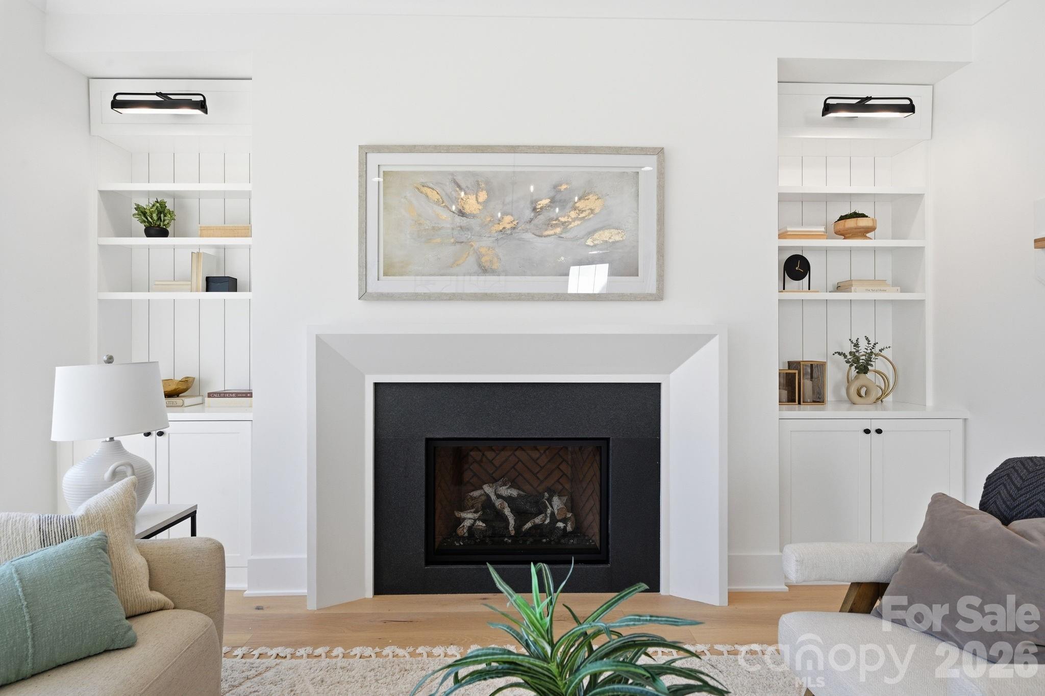 610 Walnut Street Davidson, NC 28036 - Photo 3 of 33 a living room with furniture a fireplace and wall paintings