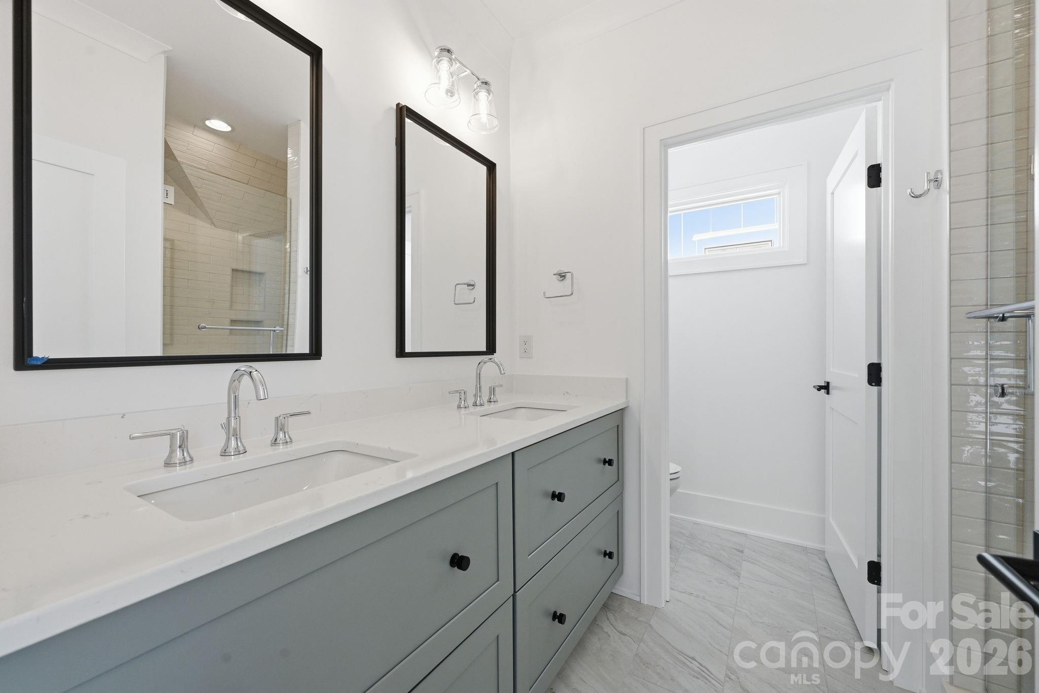 610 Walnut Street Davidson, NC 28036 - Photo 31 of 33 a bathroom with a double vanity sink and mirror
