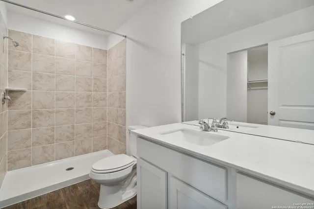 a bathroom with a sink toilet and shower