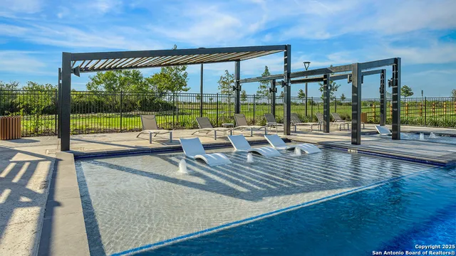 a view of a swimming pool with a lawn chairs