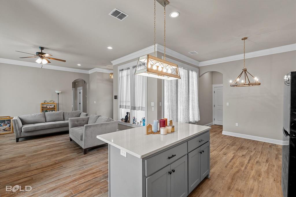 6896 Bethany Reed Circle Blanchard, LA 71107 - Photo 25 of 37 Open-concept living area with wood-finish flooring, crown molding, and recessed lighting