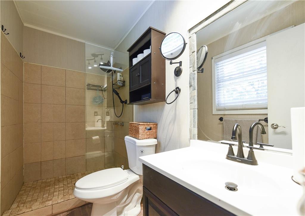 3280 Devilla Trace College Park, GA 30349 - Photo 16 of 21 a bathroom with a toilet sink and mirror