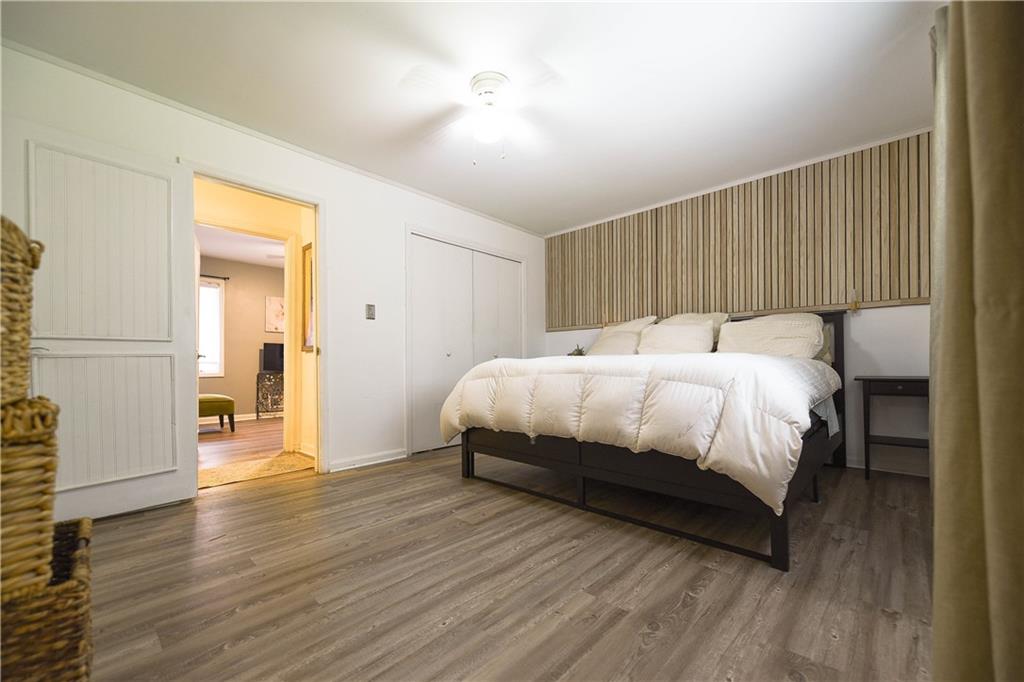 3280 Devilla Trace College Park, GA 30349 - Photo 7 of 21 a bedroom with a bed and wooden floor