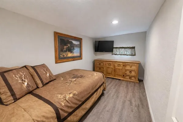 a bedroom with a bed and a desk