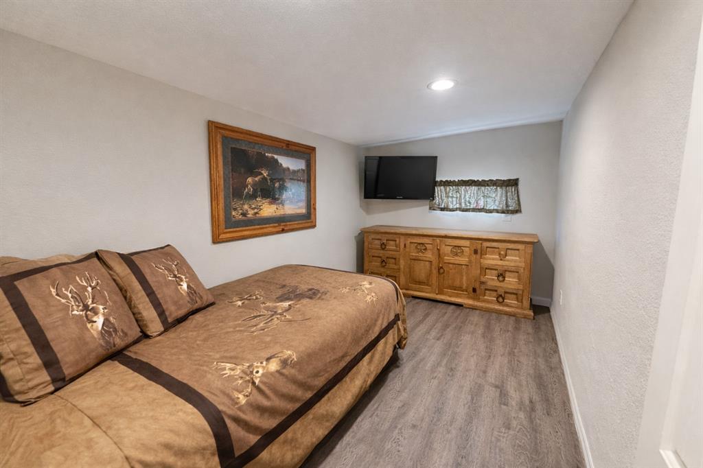 6187 Mockingbird Lane Murchison, TX 75778 - Photo 8 of 11 a bedroom with a bed and a night stand
