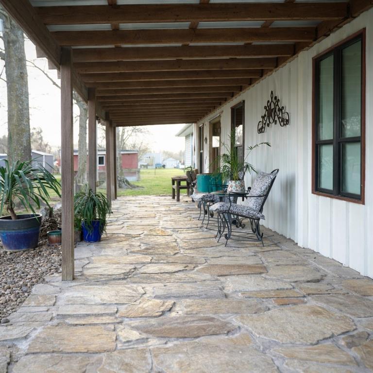 6187 Mockingbird Lane Murchison, TX 75778 - Photo 10 of 11 a view of a porch with chairs and potted plants