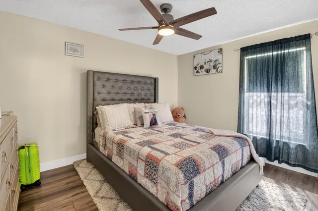 a bedroom with a bed and a chandelier