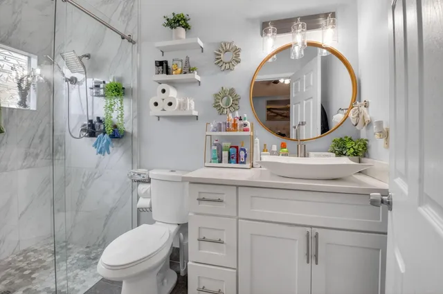 a bathroom with a toilet sink and mirror