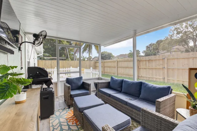 a balcony with furniture and a potted plant