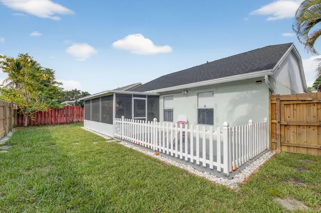 a view of a house with a yard and deck