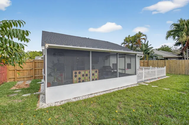 a view of a house with a yard and a garden