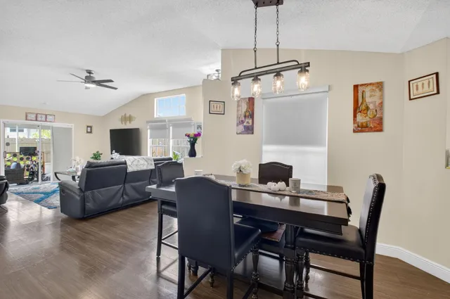 a view of a dining room with furniture window and wooden floor