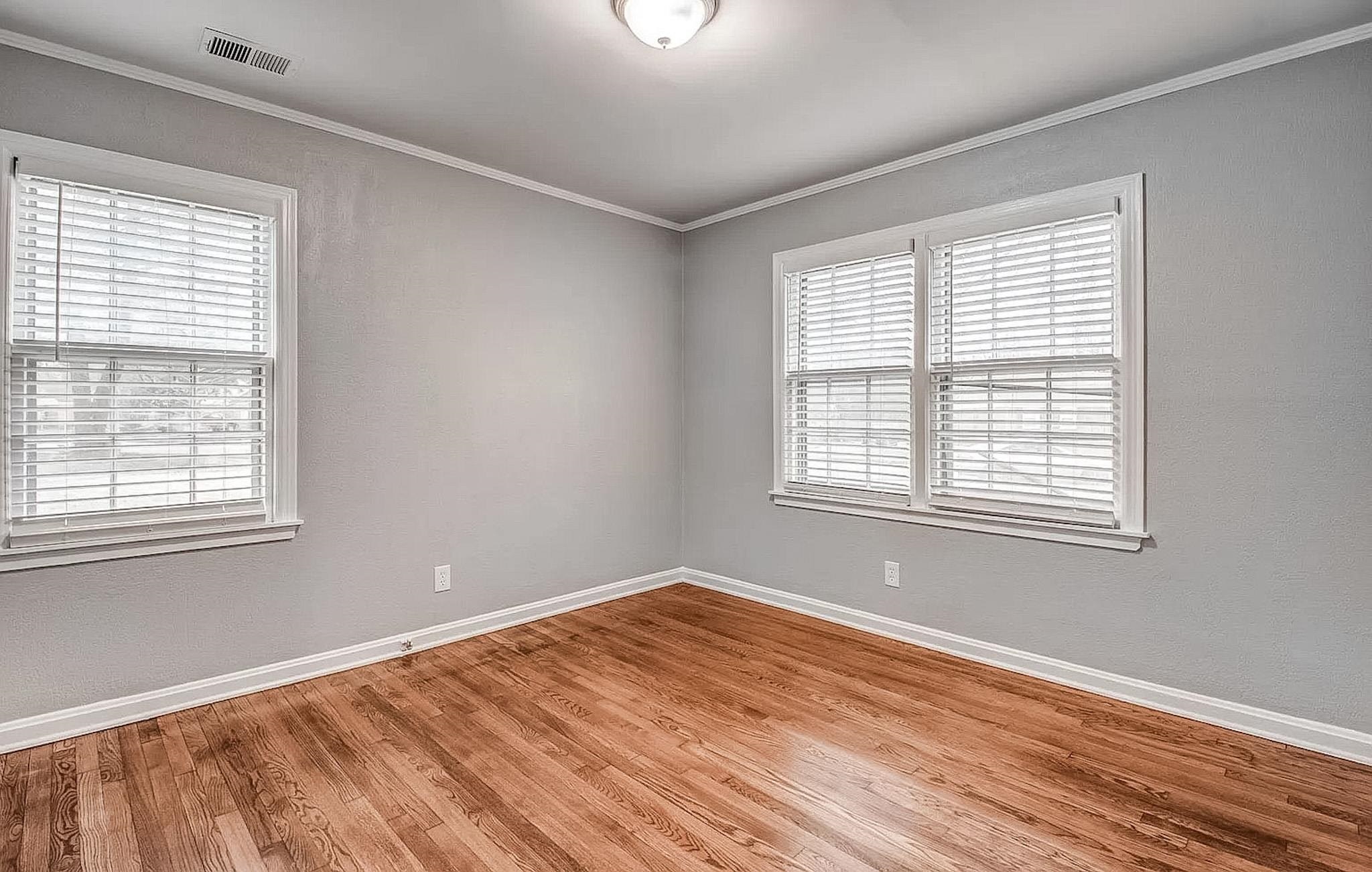 4402 Boyce Road Memphis, TN 38117 - Photo 12 of 13 a view of an empty room with wooden floor and a window