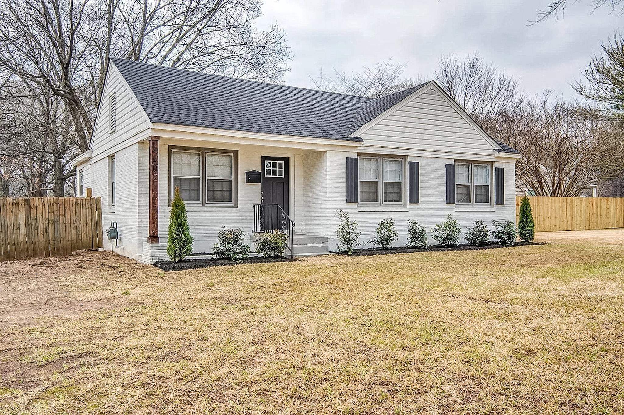 4402 Boyce Road Memphis, TN 38117 - Photo 2 of 13 a front view of a house with a yard and garage